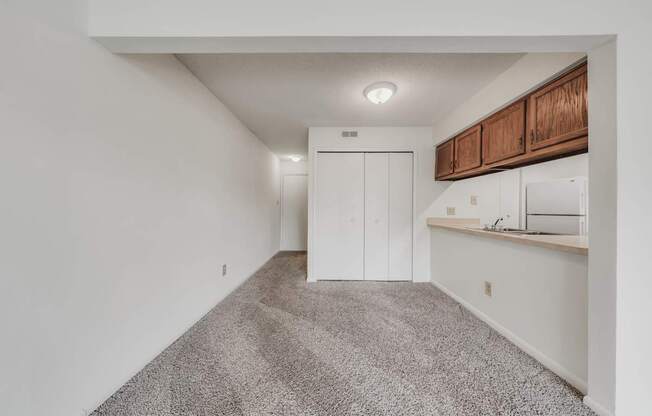 A room with a carpeted floor and a white wall.
