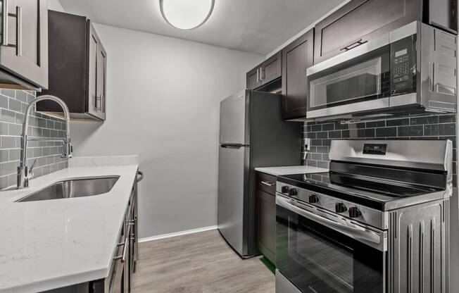a kitchen with stainless steel appliances and black and white appliances