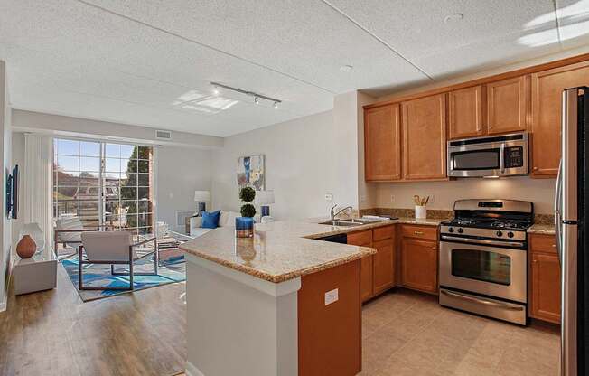 A kitchen with a refrigerator, oven, and microwave.