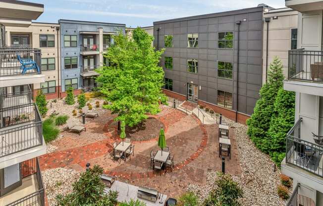 an aerial view of a courtyard with trees and buildings