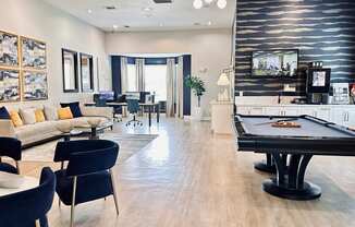 a living room with a pool table and a tv