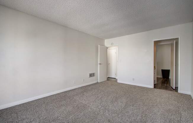a bedroom with a carpeted floor and white walls