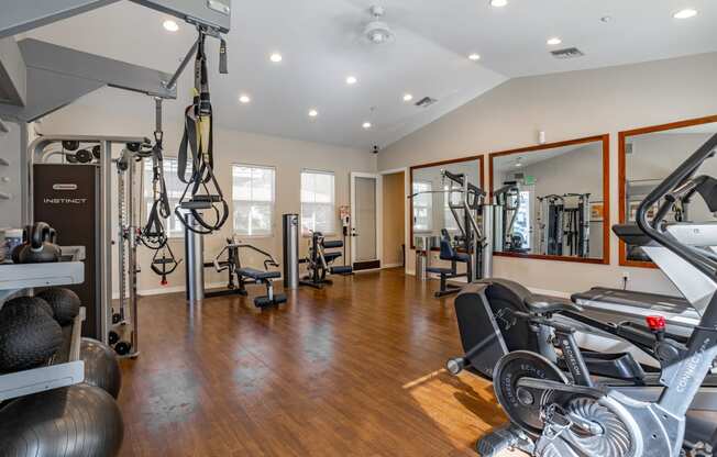 a home gym with exercise equipment and mirrors at Canyon Crest, Riverside, CA