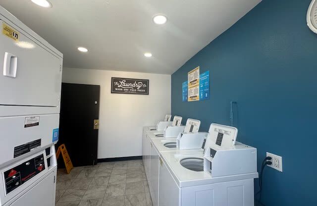 a laundry room with a bunch of washing machines