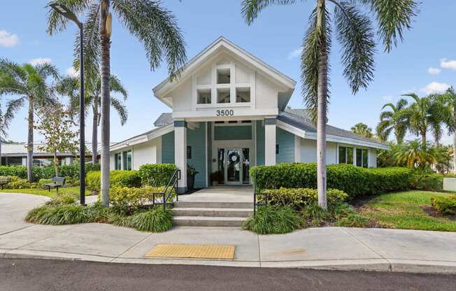 the front of a house with palm trees