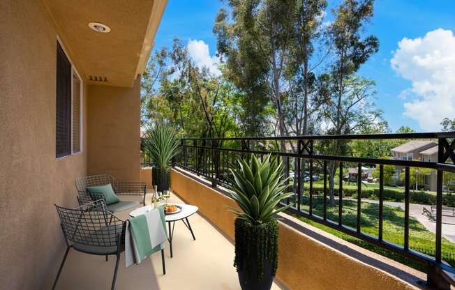 a patio with a table and chairs on a balcony