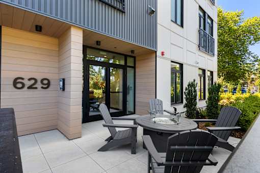 A modern house numbered 629 with a patio and chairs.