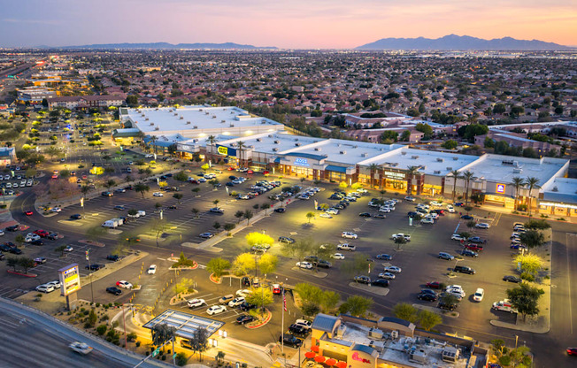A parking lot with cars and a building in the background.
