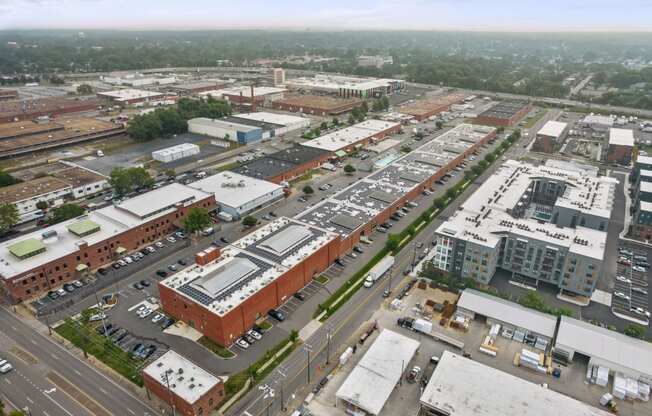 a view from the top of a building of a city street and parking lot