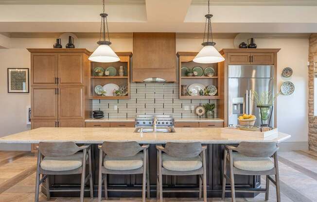 A kitchen with a table and chairs in front of it.