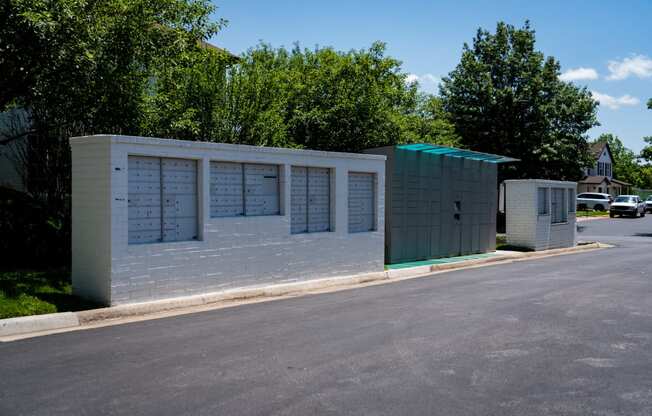 a small building with lockers on the side of a street