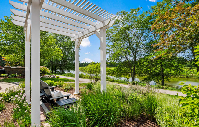 a pergola with a picnic table in a garden