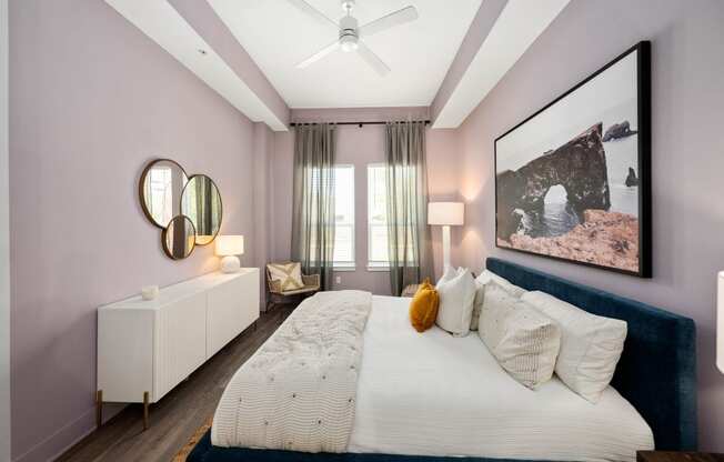 a bedroom with pink walls and a large bed