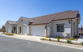 a home with a gray exterior and a white garage door