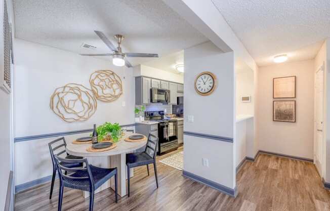 a dining room and kitchen with a clock on the wall