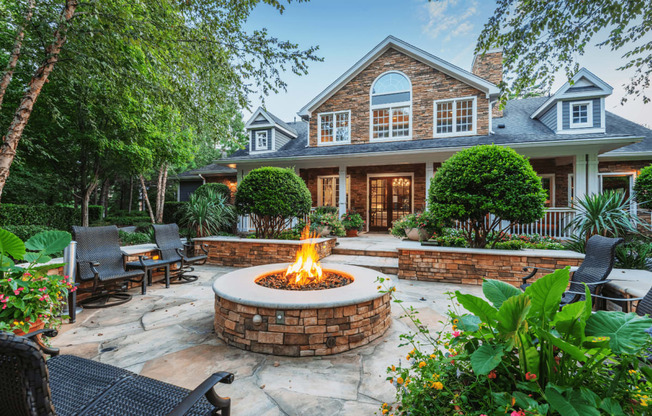 a backyard with a fire pit and patio furniture