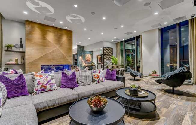 A modern living room with a grey sofa and a black coffee table.