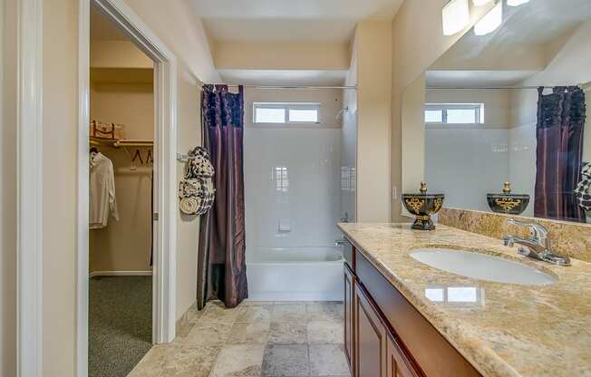 a bathroom with a shower and a sink and a mirror