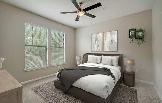 a bedroom with a large bed and a ceiling fan