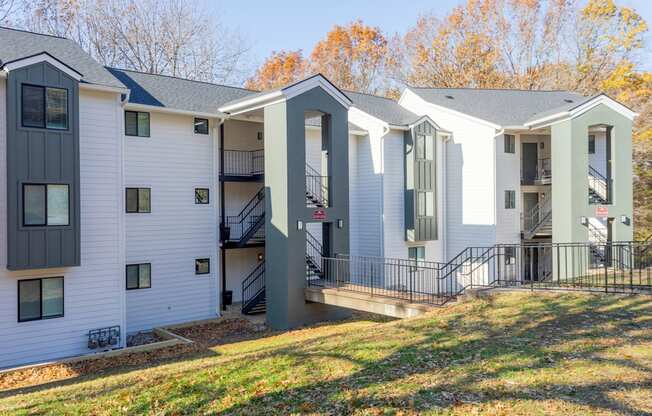 A modern two-story apartment building with white and grey exterior.