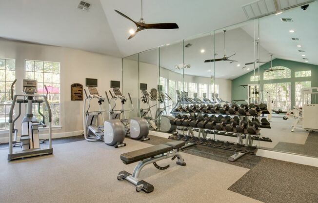 View of Fitness Center with Cardio Machines, and Free Weights at Raveneaux Apartments