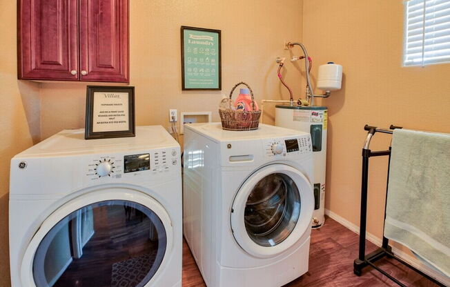 a washer and dryer in a laundry room with two washing machines at Villas on Bell, Phoenix, AZ 85053