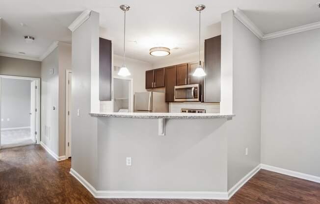 an empty apartment with a kitchen and a living room