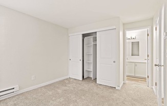 A room with a white door and a white cabinet.