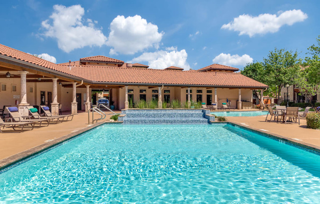 a swimming pool with a house in the background