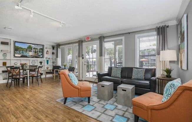 a living room with couches and chairs and a dining room table