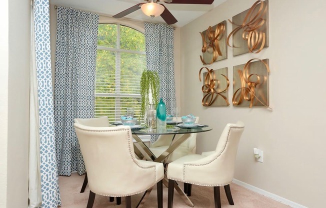 a dining room with a table and chairs and a window