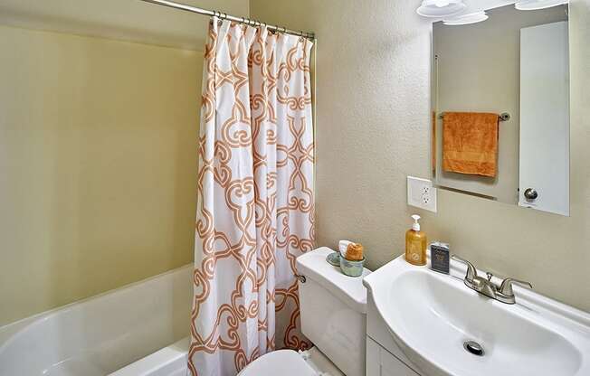 a bathroom with a shower curtain and a sink and a toilet  at Woodhaven, Everett, Washington