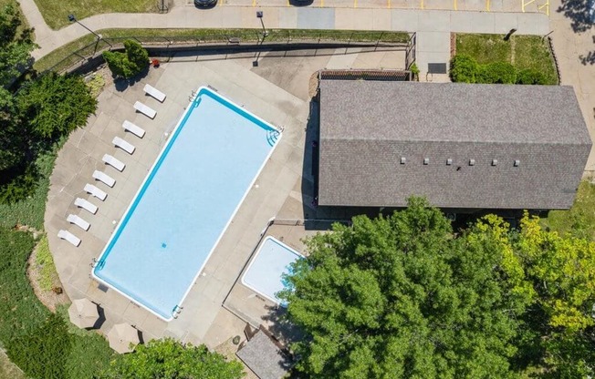 an aerial view of a swimming pool and clubhouse