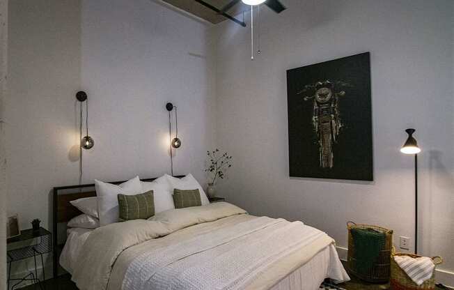 A bedroom with a large bed and a ceiling fan.