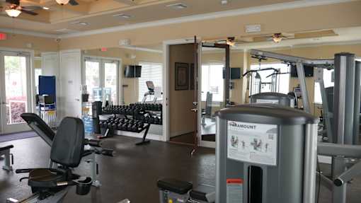 A gym with a variety of equipment including a treadmill.