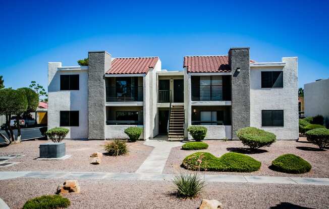 an apartment building with dogs in a courtyard