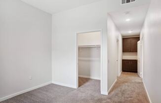 a bedroom with a medium sized bed and a closet with a white door at Rancho Belago, California, 92555