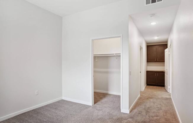 a bedroom with a medium sized bed and a closet with a white door at Rancho Belago, California, 92555