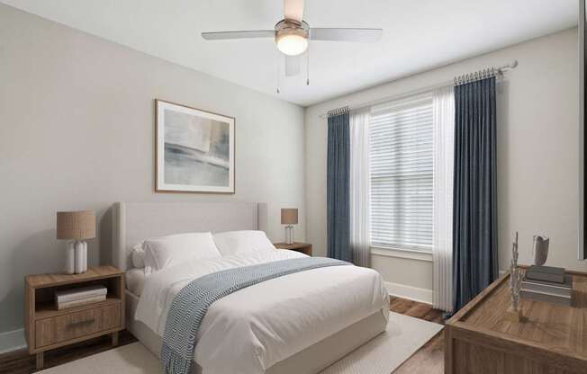 A bedroom with a large bed and a ceiling fan.