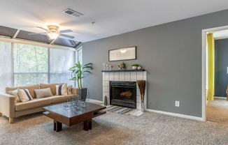 a living room with a fireplace and a large window