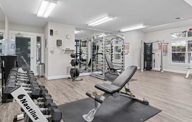 A gym with weights and strength training machines at Abbey Rowe Apartments in Olympia, WA
