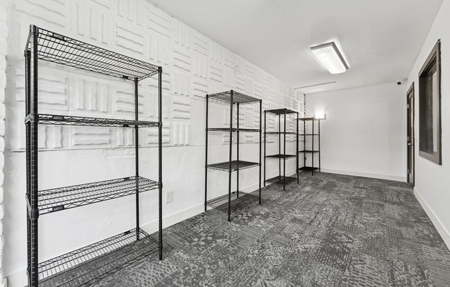 A long hallway with empty shelving and a carpeted floor.