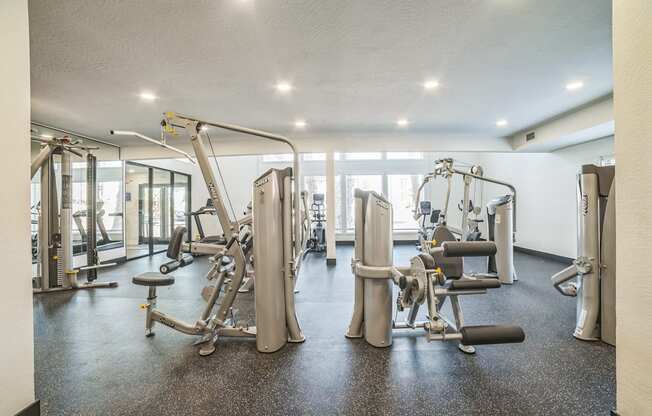 A gym with a variety of equipment including a leg press machine.