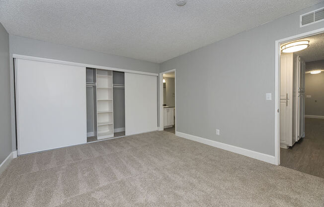 One Bedroom Apartments in Sacramento, CA - Vue at the Lake Spacious Bedroom with Large Closet and Carpet Flooring