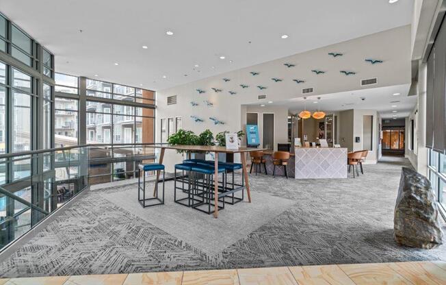 a large room with a bar and chairs