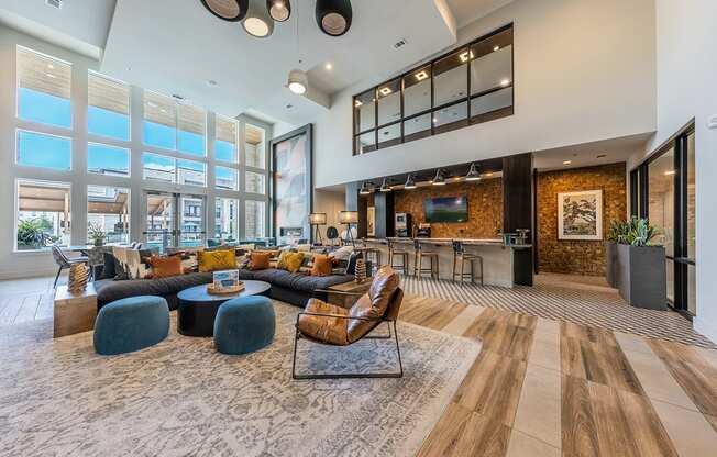 A modern living room with a large sectional sofa, a coffee table, and a TV.