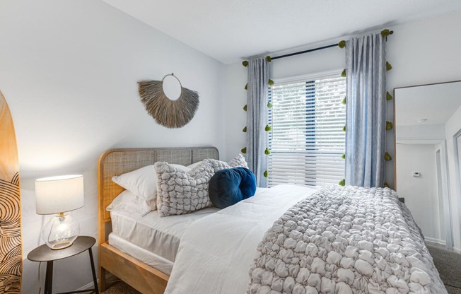 a bedroom with a large bed and a window