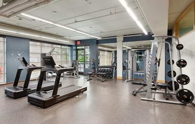 a spacious fitness center with treadmills and other exercise equipment