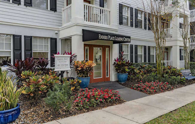 A white building with a sign that says Enders Place Leasing Center.
