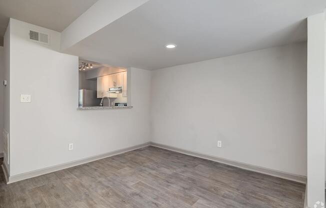 A room with a kitchenette in the corner.